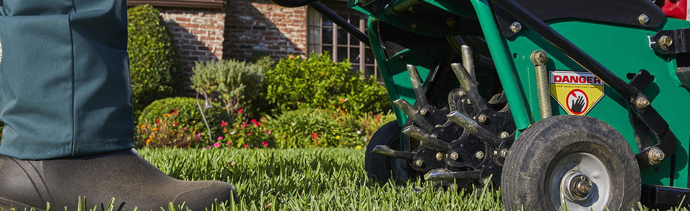 TruGreen specialist performing an aeration service