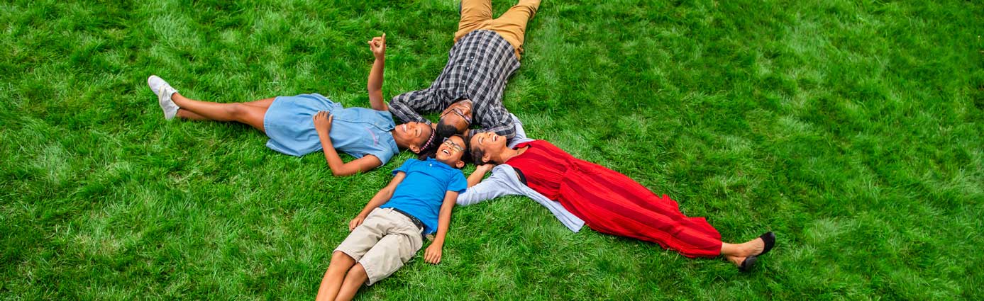 Family laying on grass