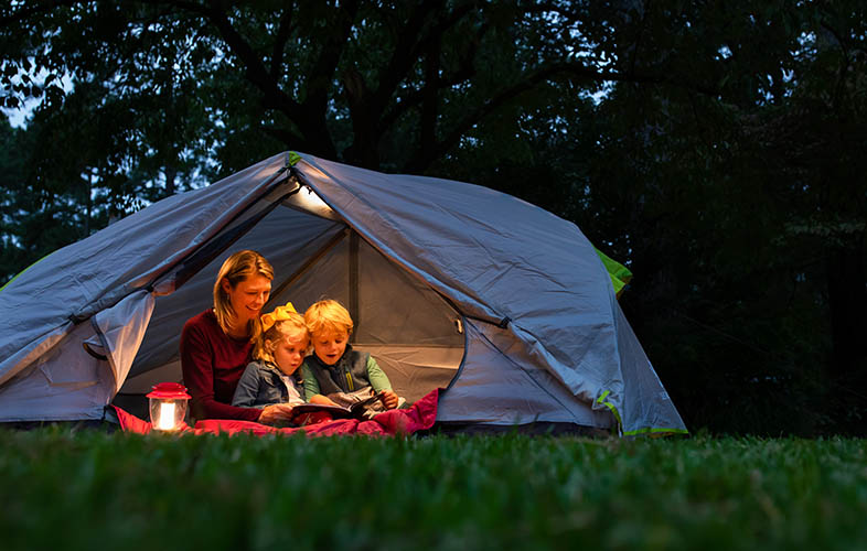 family camping in backyard