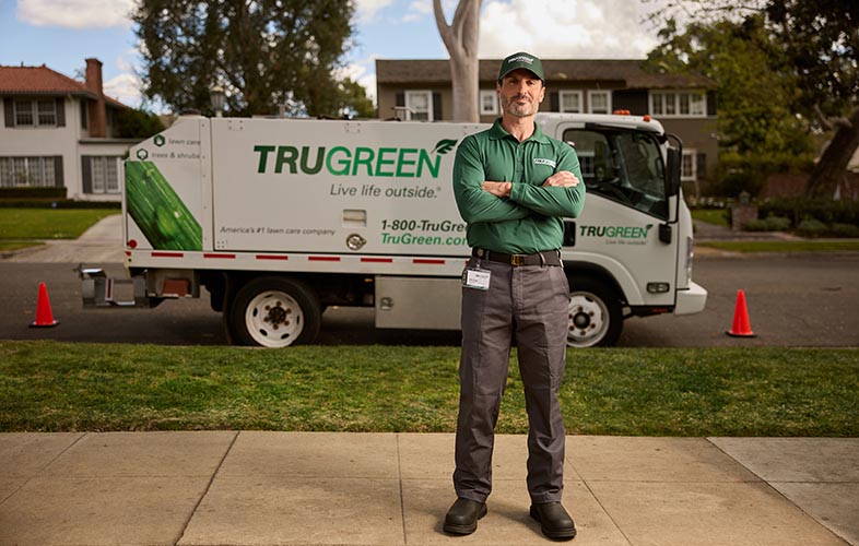 TruGreen lawn specialist with TruGreen truck