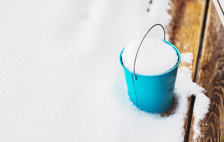 Bucket covered in snow