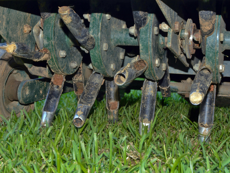 Close up of tines on a core aerator