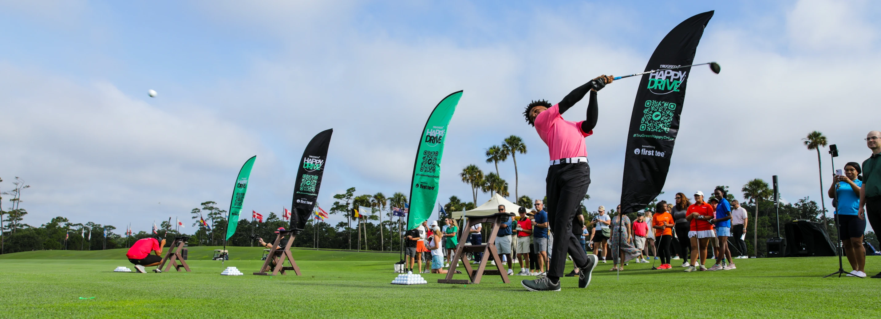 Golfers doing a "happy swing" at the Happy Drive Challenge kickoff event