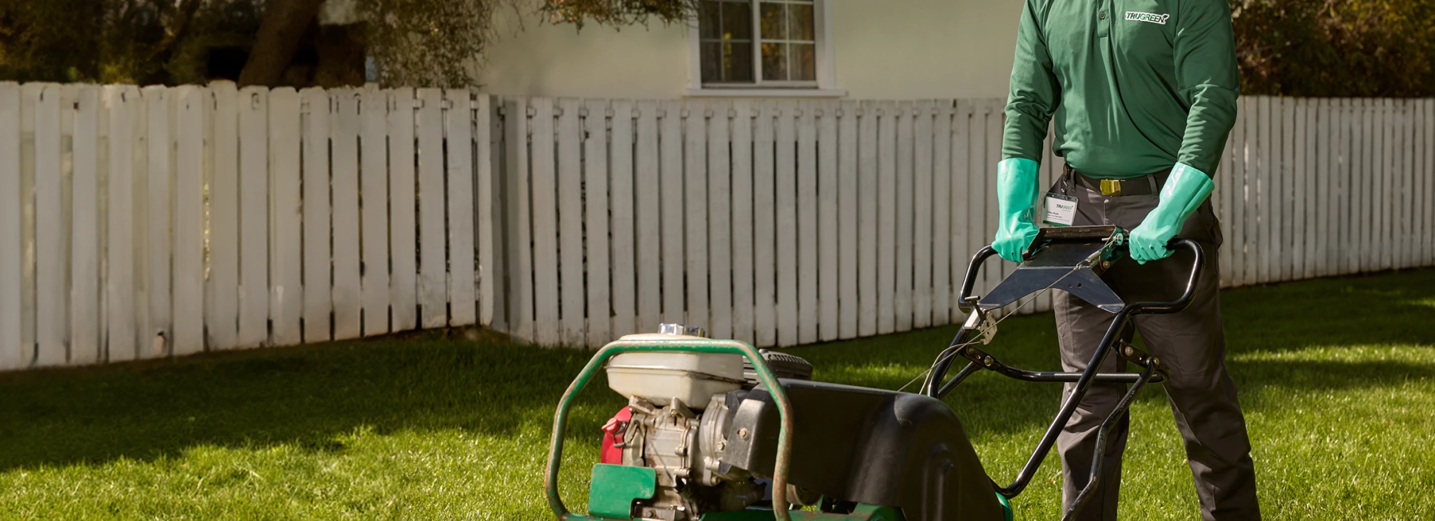 TruGreen specialist aerating a lawn