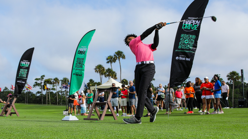 Golfers doing a "happy swing" at the Happy Drive Challenge kickoff event
