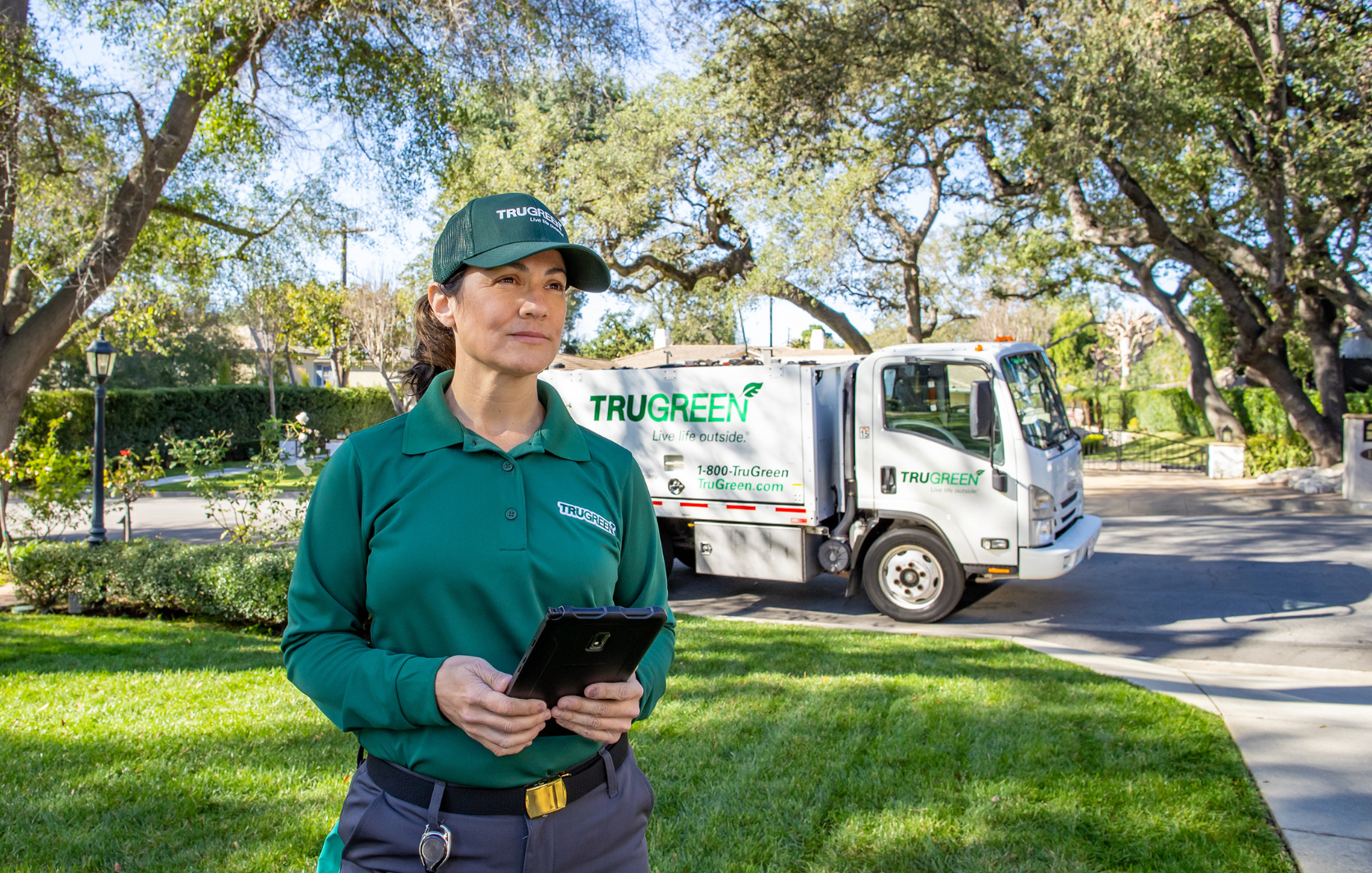 Lawn care specialist standing by truck