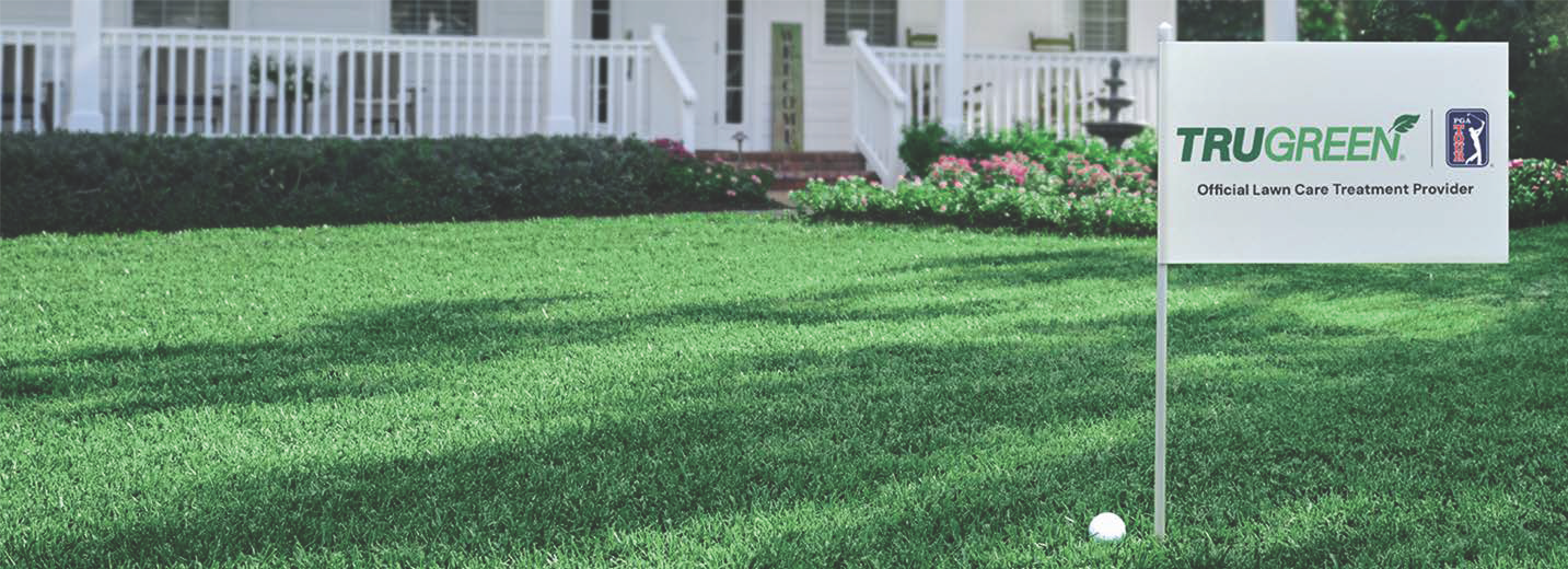 Lush, green lawn with a flag in it that has the TruGreen logo and the PGA TOUR logo