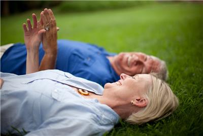 Older couple lying on a lawn