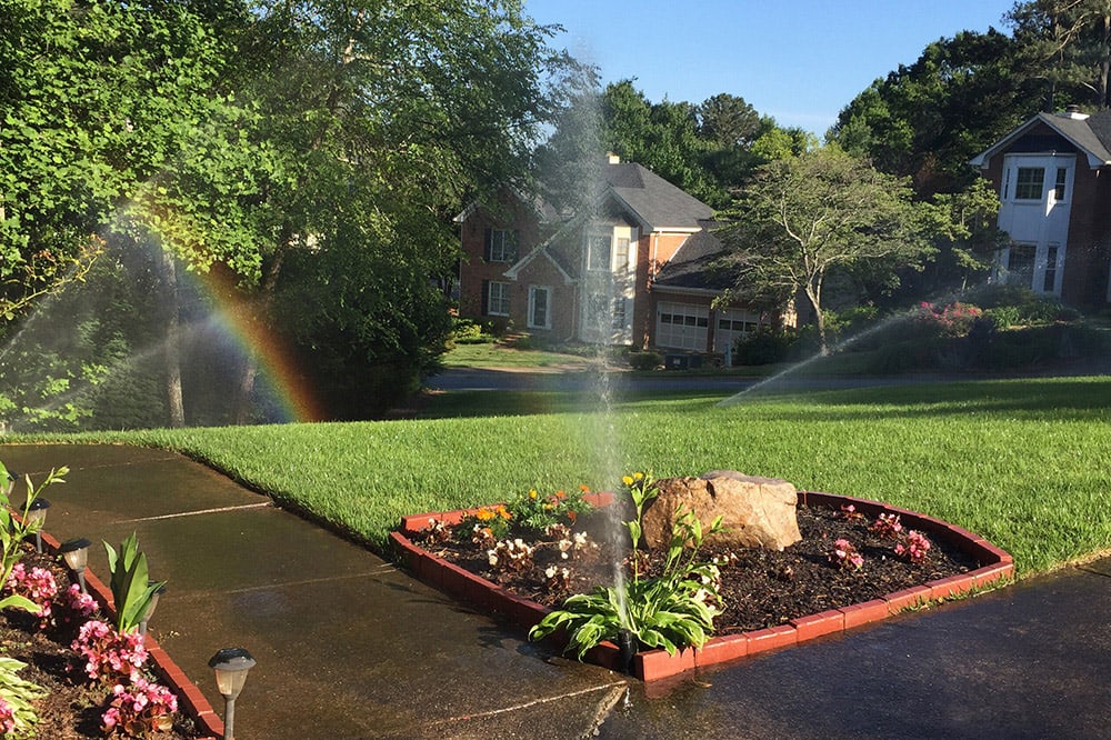 Automatic sprinklers watering a lawn