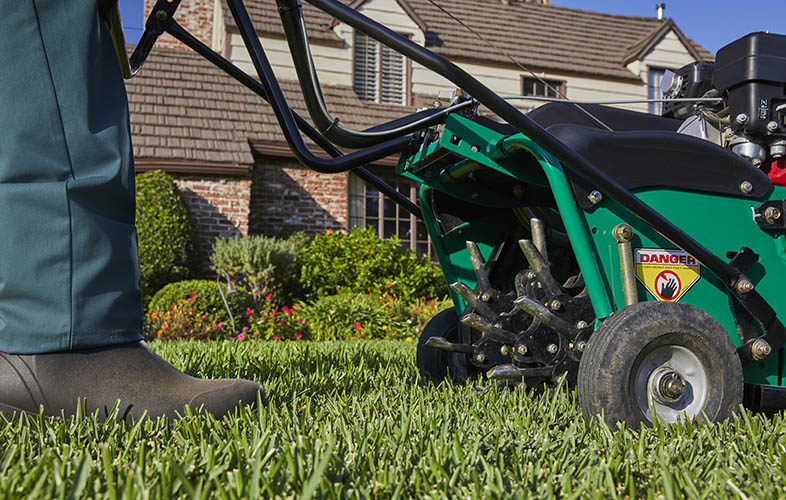 TruGreen specialist performing an aeration service